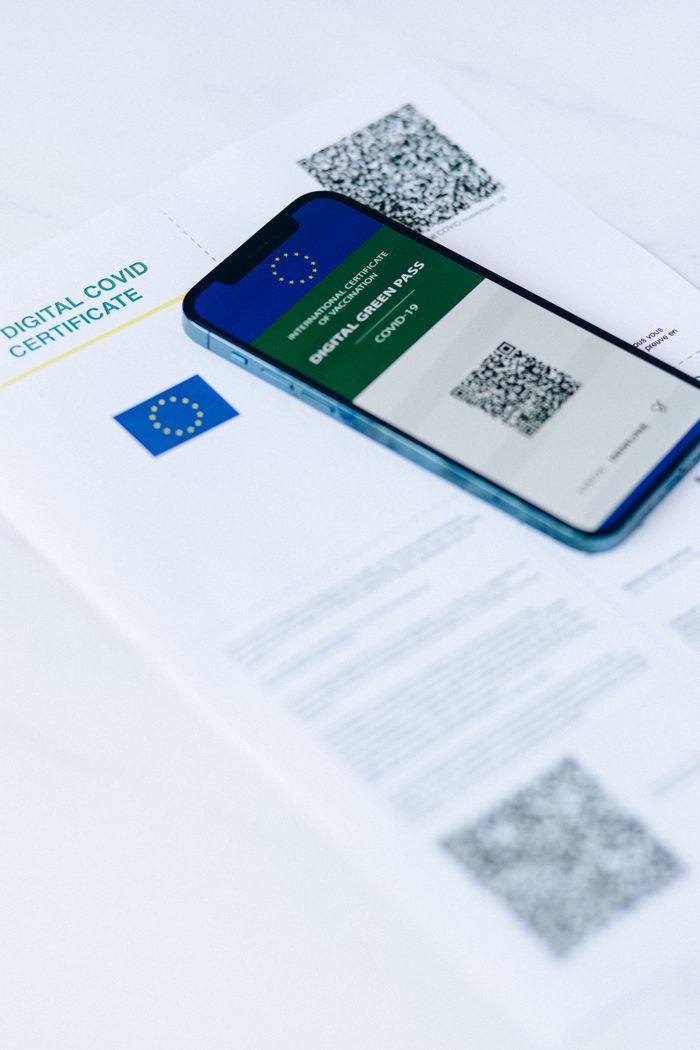 Home Smartphone showing digital COVID pass on document with QR codes.